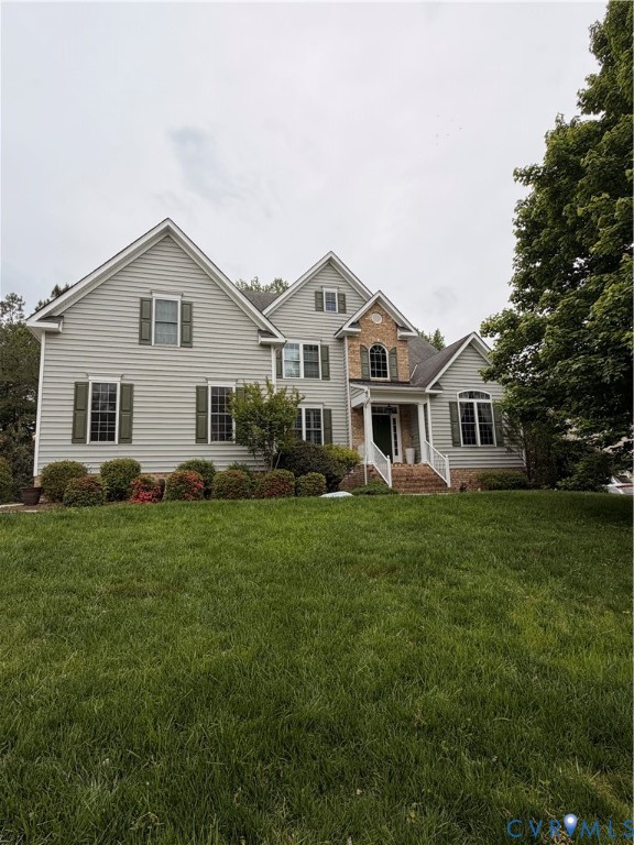 Two-story home with a brick and siding facade, fea