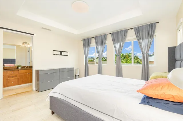 a bedroom with a large bed and a window