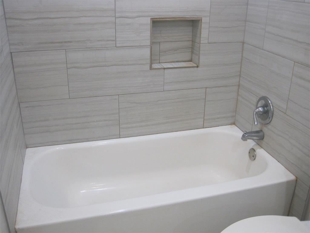 6478 Argo Street Dallas, TX 75214 - Photo 12 of 15 a bathroom with a bathtub