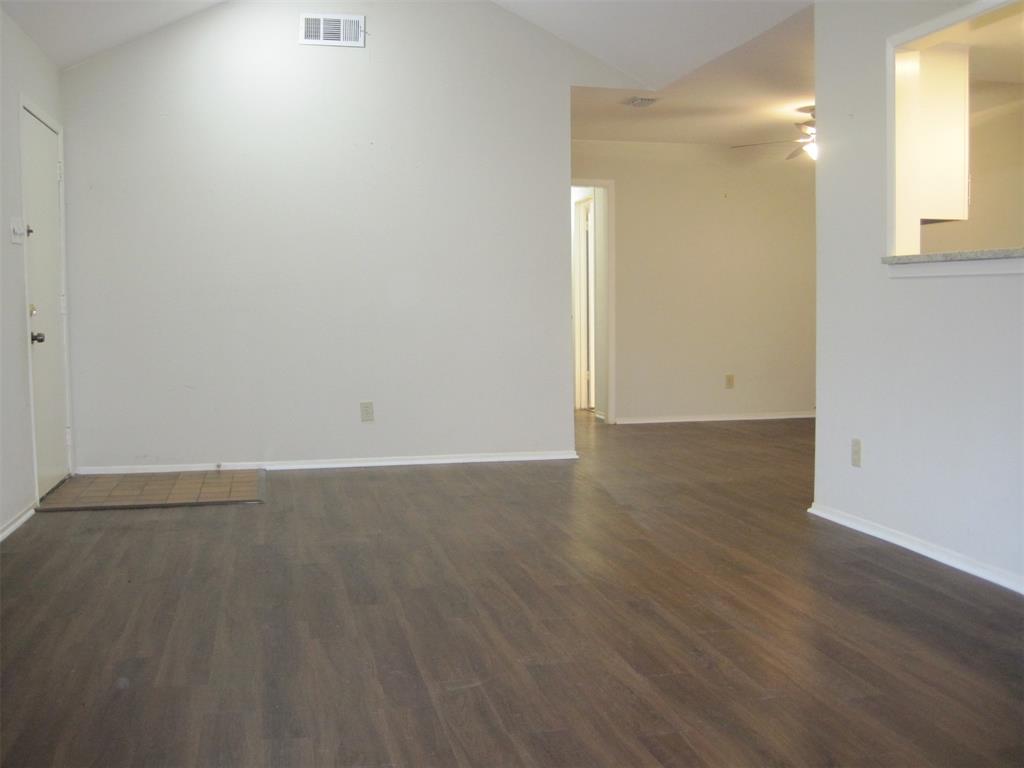 6478 Argo Street Dallas, TX 75214 - Photo 2 of 15 an empty room with wooden floor and windows