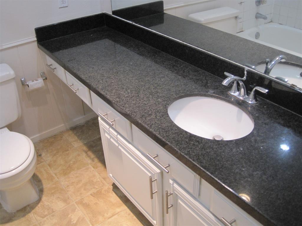 6478 Argo Street Dallas, TX 75214 - Photo 8 of 15 a bathroom with a granite countertop sink and a mirror