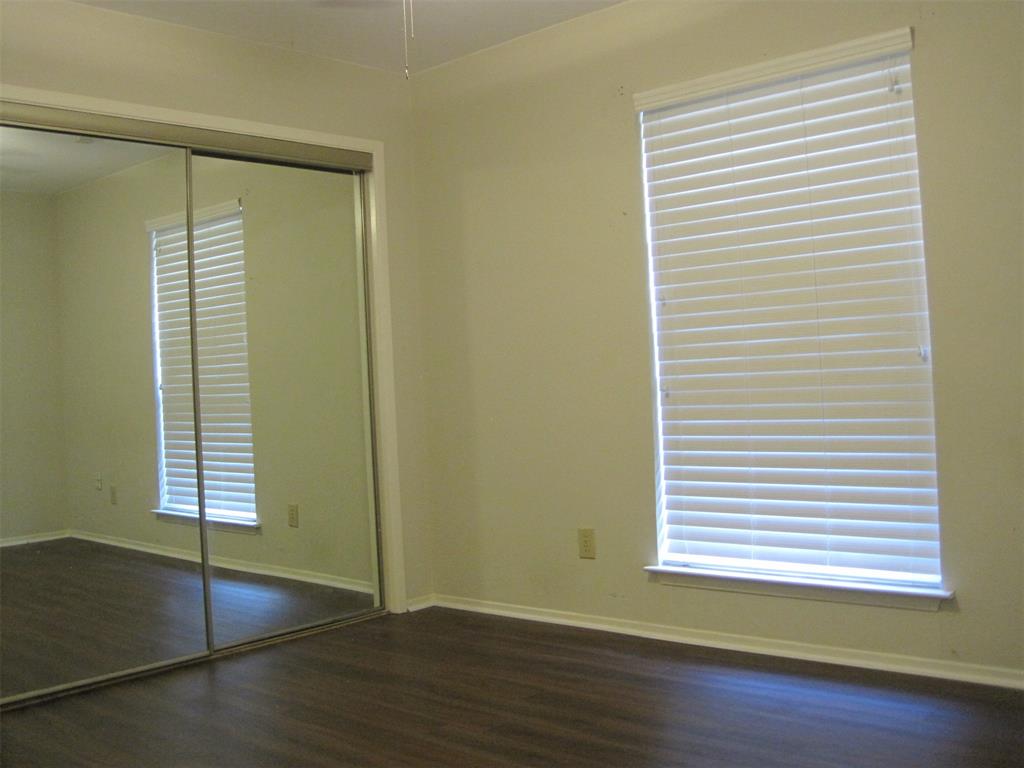 6478 Argo Street Dallas, TX 75214 - Photo 9 of 15 an empty room with wooden floor and windows