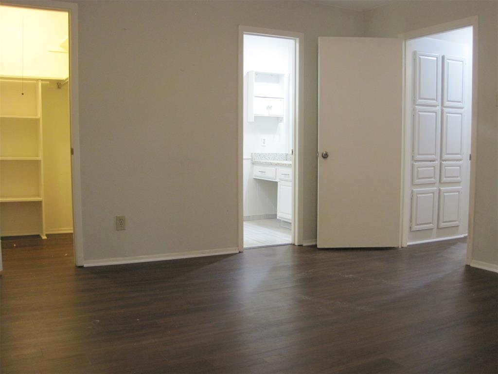 6478 Argo Street Dallas, TX 75214 - Photo 10 of 15 a view of an empty room with wooden floor and a window
