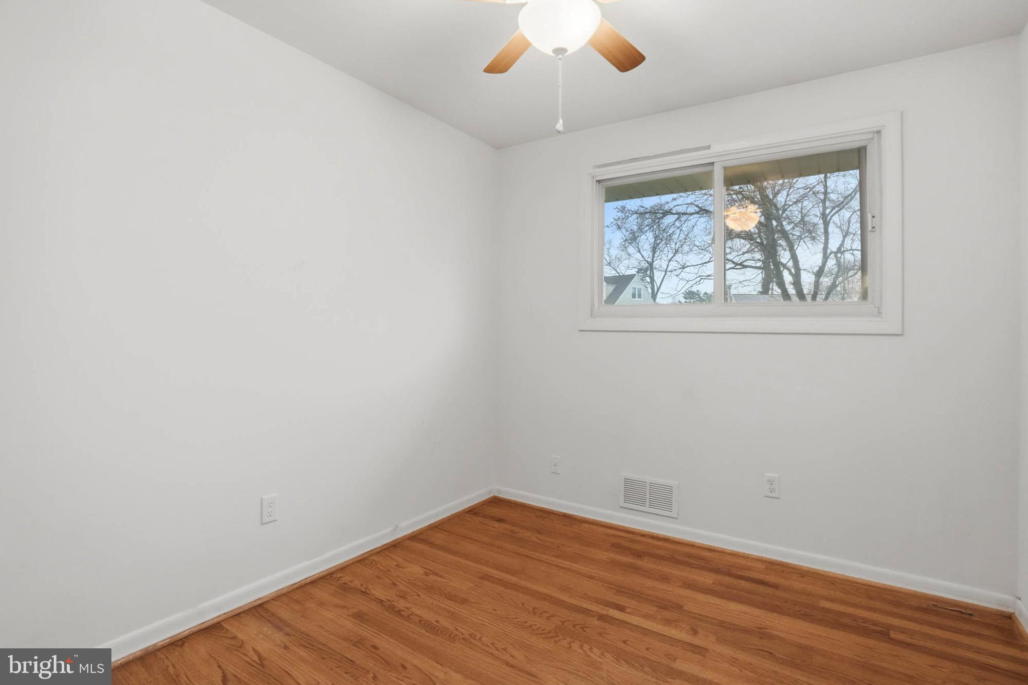 1909 Pagham Road Glen Burnie, MD 21061 - Photo 20 of 30 an empty room with wooden floor and window