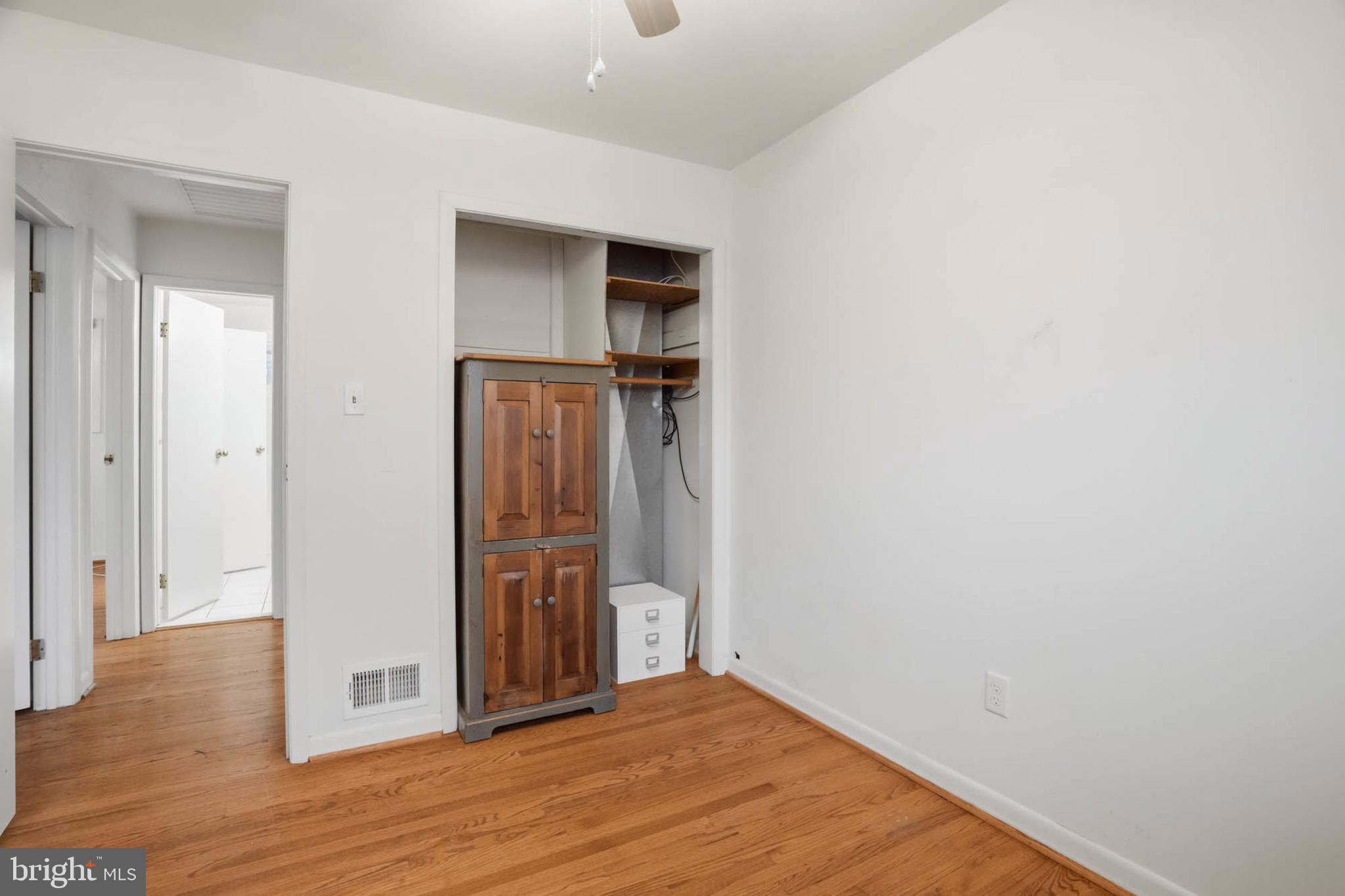 1909 Pagham Road Glen Burnie, MD 21061 - Photo 21 of 30 a view of an empty room with wooden floor and closet