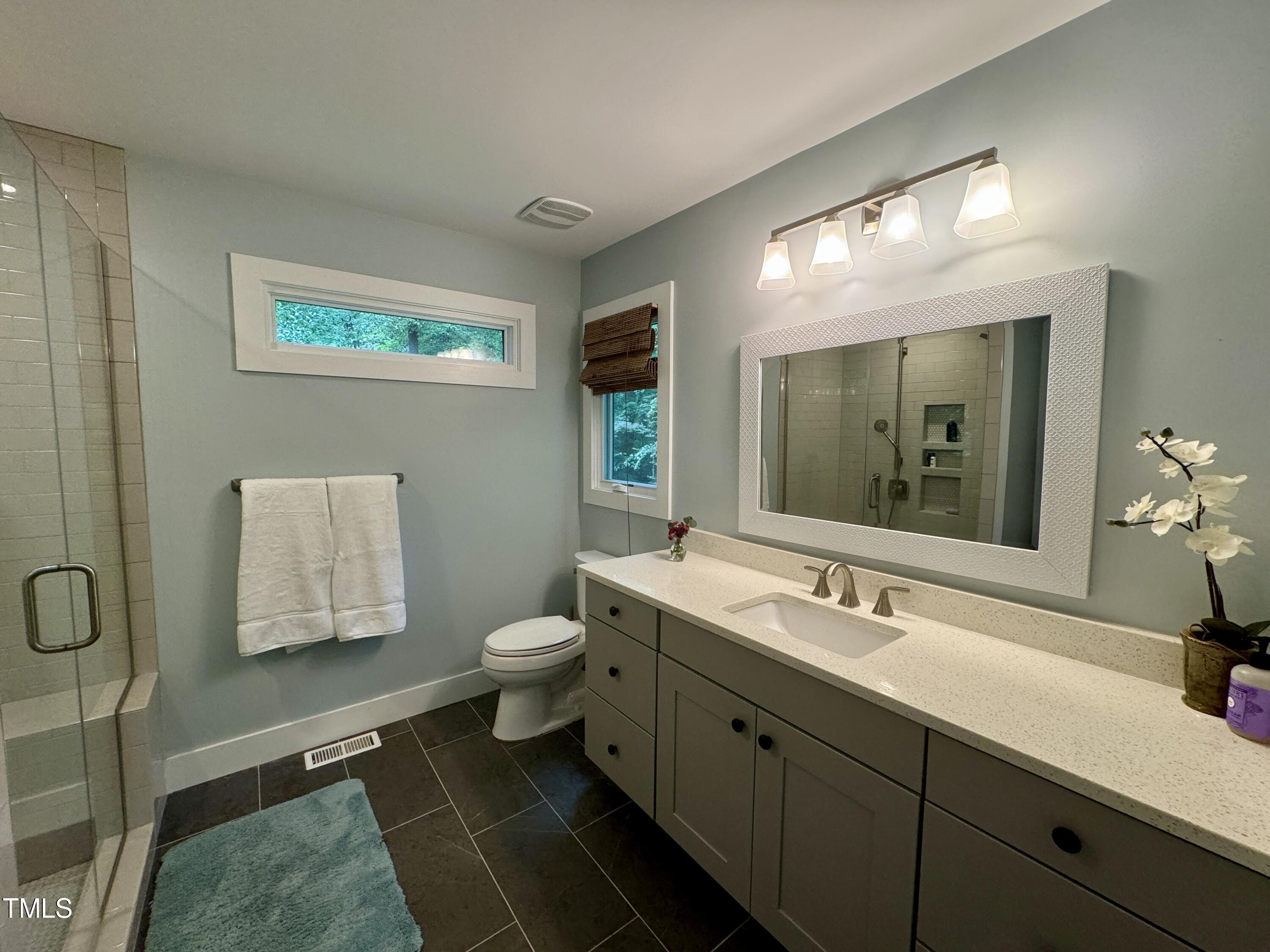 11904 Deer Run Raleigh, NC 27614 - Photo 19 of 61 a bathroom with a toilet sink and mirror