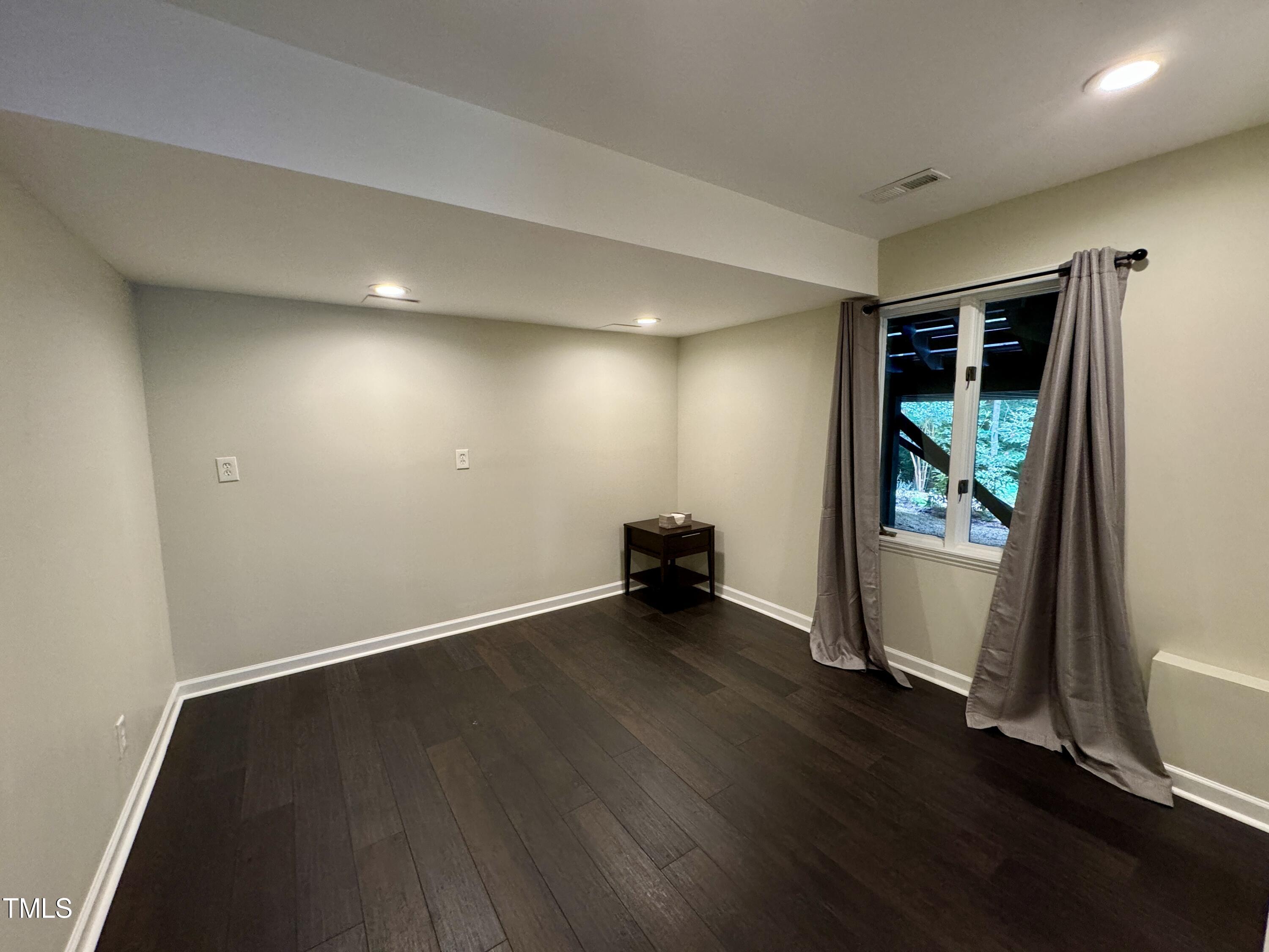 11904 Deer Run Raleigh, NC 27614 - Photo 28 of 61 an empty room with wooden floor and windows