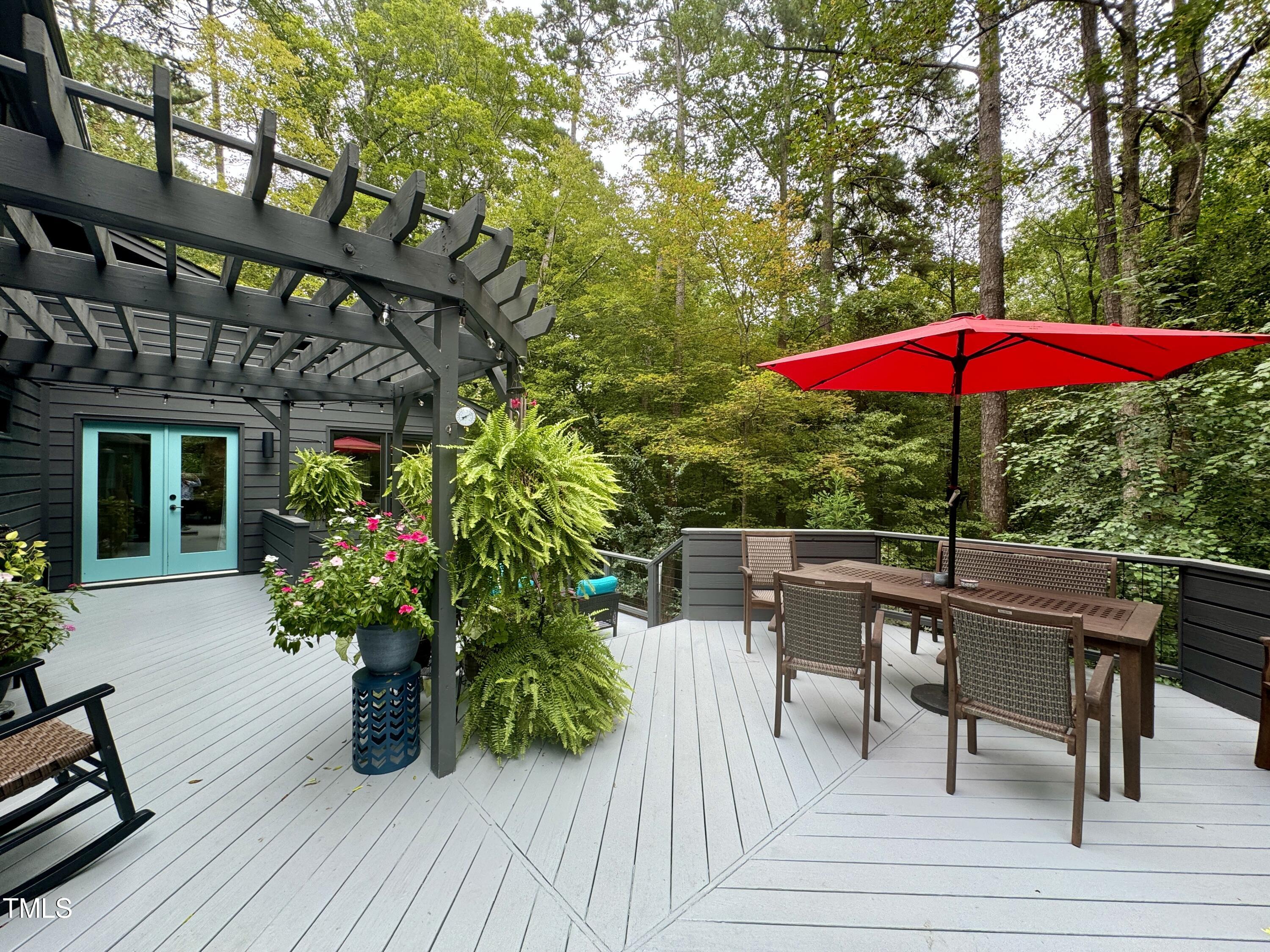 11904 Deer Run Raleigh, NC 27614 - Photo 54 of 61 a patio with wooden floor a yard a table and chairs