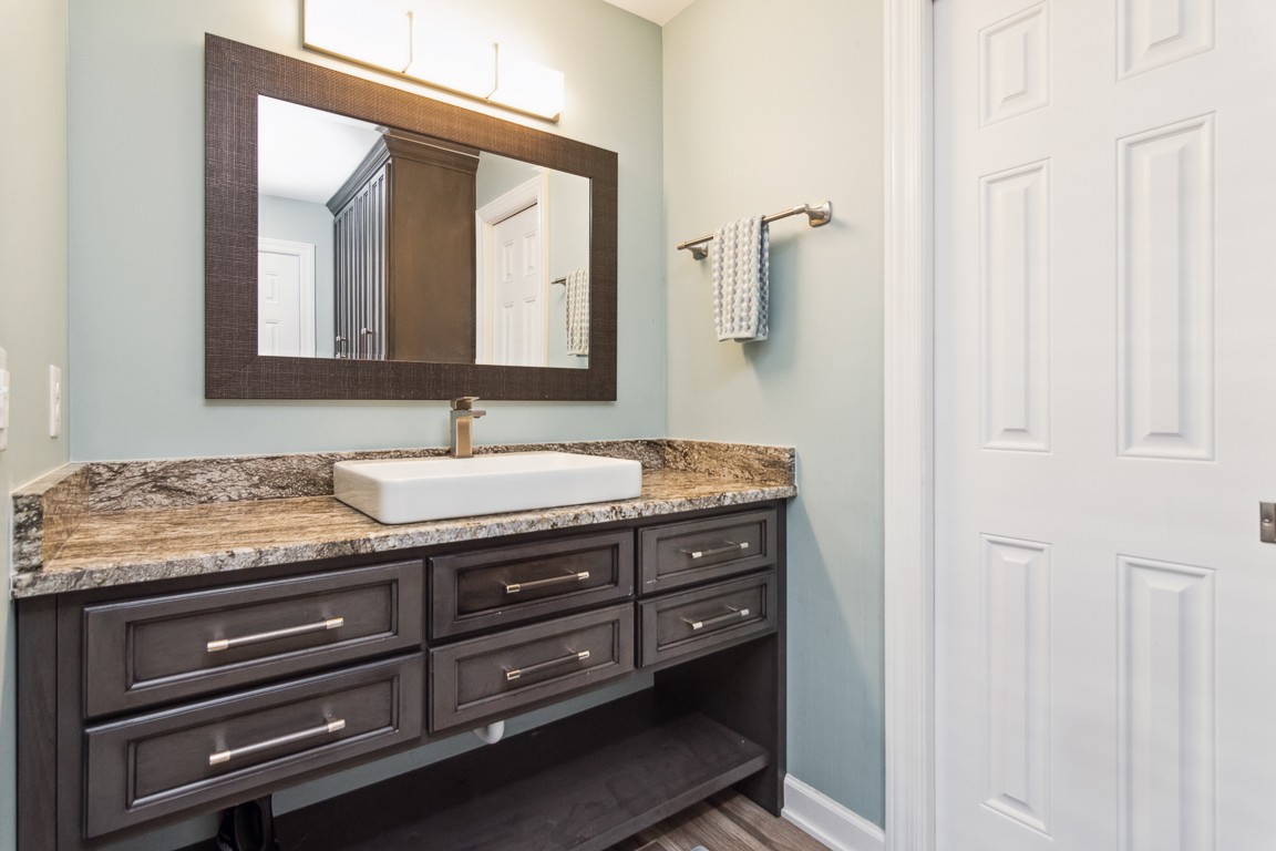 1241 General George Patton Road Nashville, TN 37221 - Photo 12 of 23 a bathroom with a granite countertop sink and a mirror