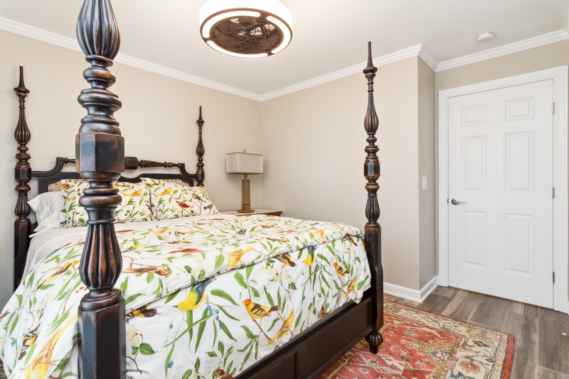 1241 General George Patton Road Nashville, TN 37221 - Photo 15 of 23 a bedroom with a bed and a chandelier