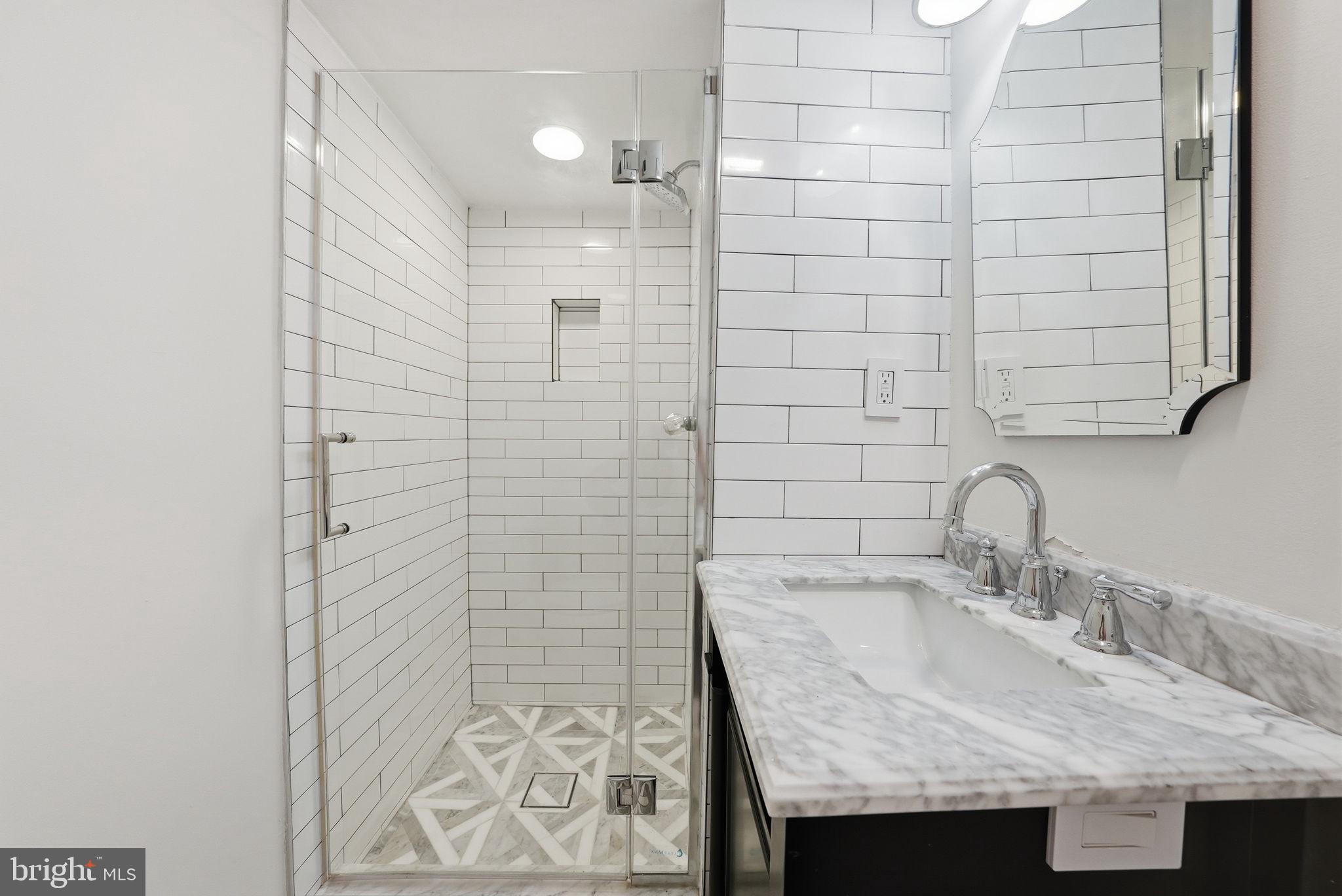 1200 East Capitol Street Northeast, Unit 1 Washington, DC 20002 - Photo 28 of 31 a bathroom with a sink and a mirror
