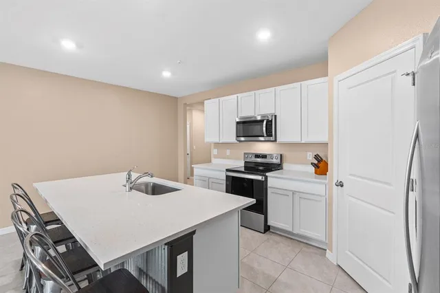 a living room with furniture and kitchen view
