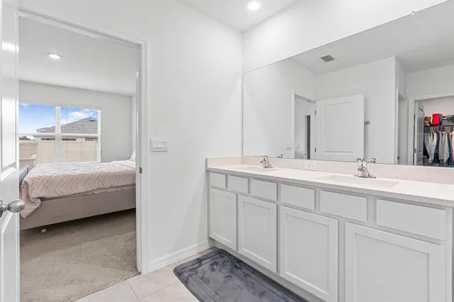 a bathroom with double sink and mirror