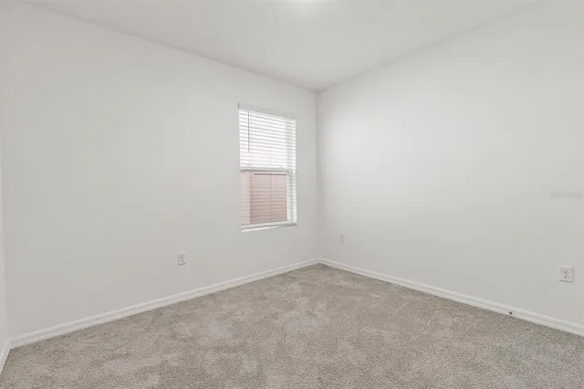 a front view of a house with a garden and mountain view
