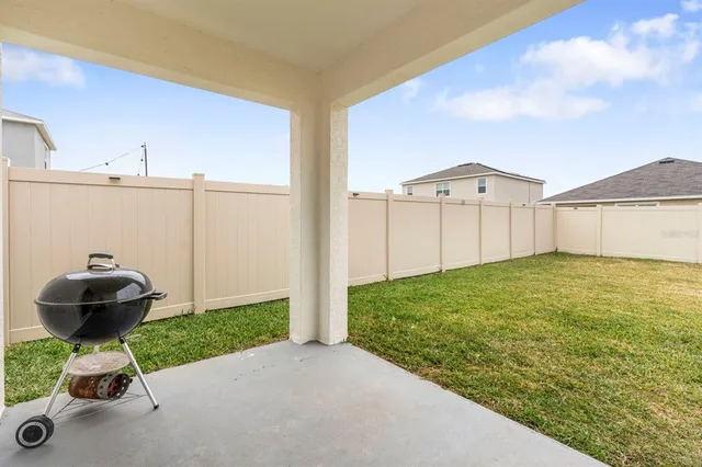 a view of an ocean with a big yard and mountain view