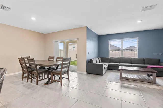 a living room with furniture a kitchen view and a kitchen view