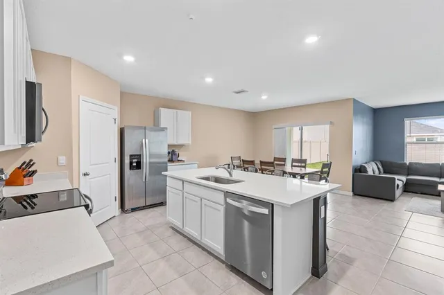 a kitchen that has a sink and a stove top oven