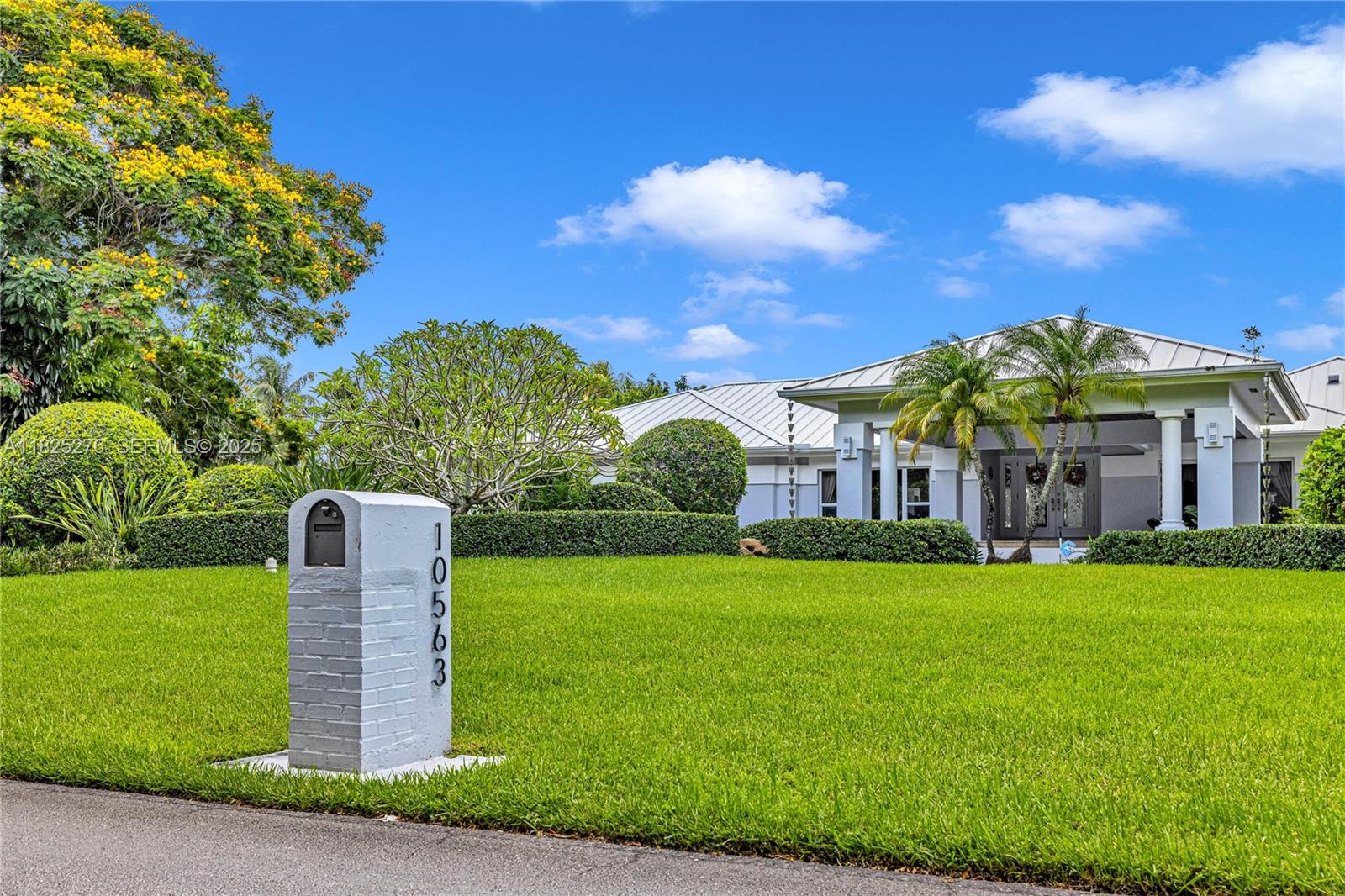 a front view of a house with a garden