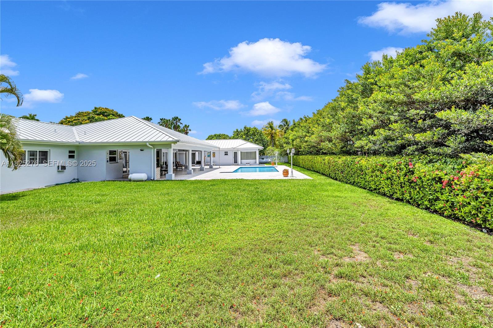 10563 Southwest 92nd Avenue Miami, FL 33176 - Photo 13 of 87 a view of house with garden and tall trees