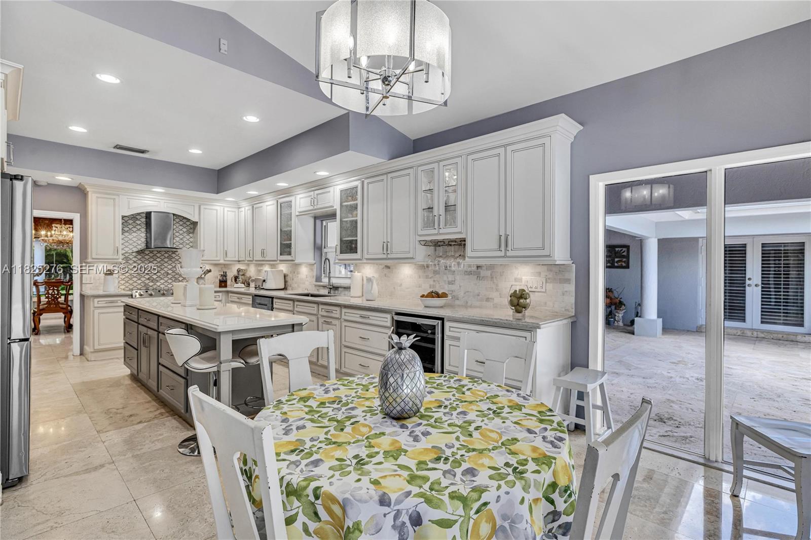 10563 Southwest 92nd Avenue Miami, FL 33176 - Photo 36 of 87 a kitchen with stainless steel appliances granite countertop a stove top oven a sink a dining table and chairs