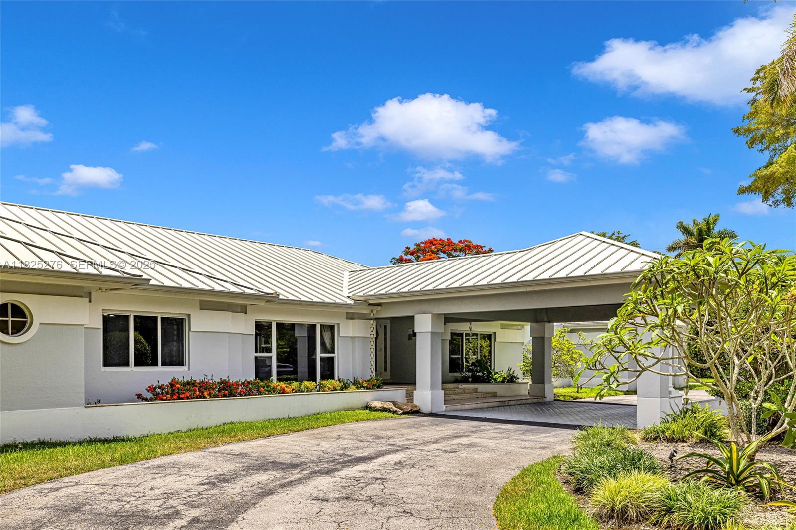 10563 Southwest 92nd Avenue Miami, FL 33176 - Photo 68 of 87 a front view of a house with a garden and porch