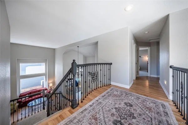 a view of entryway and hall with wooden floor