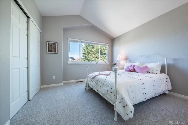 a bedroom with bed and window