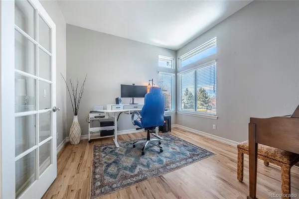 a dining room with furniture a chandelier and wooden floor