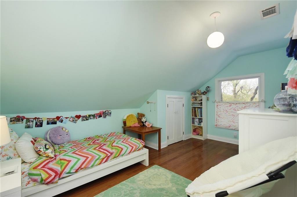 4412 Barrow Avenue, Unit A Austin, TX 78751 - Photo 21 of 28 Bedroom featuring vaulted ceiling and dark wood-type flooring