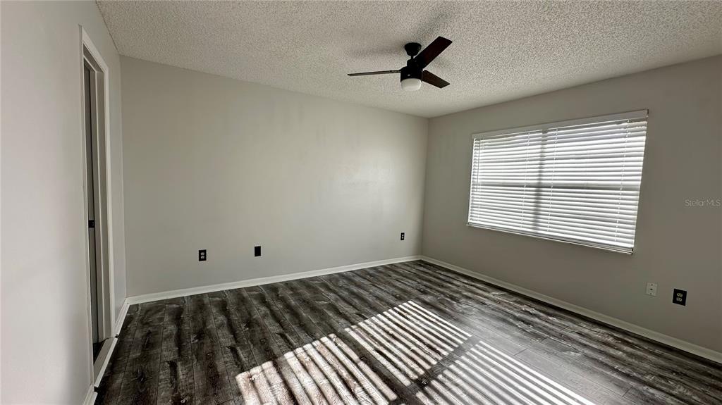 6104 Topher Trail, Unit 6104 Mulberry, FL 33860 - Photo 11 of 19 a view of a room with wooden floor and windows