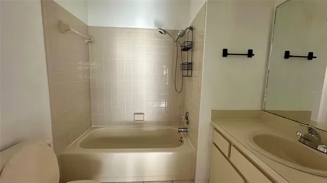 a bathroom with a tub a sink and a shower
