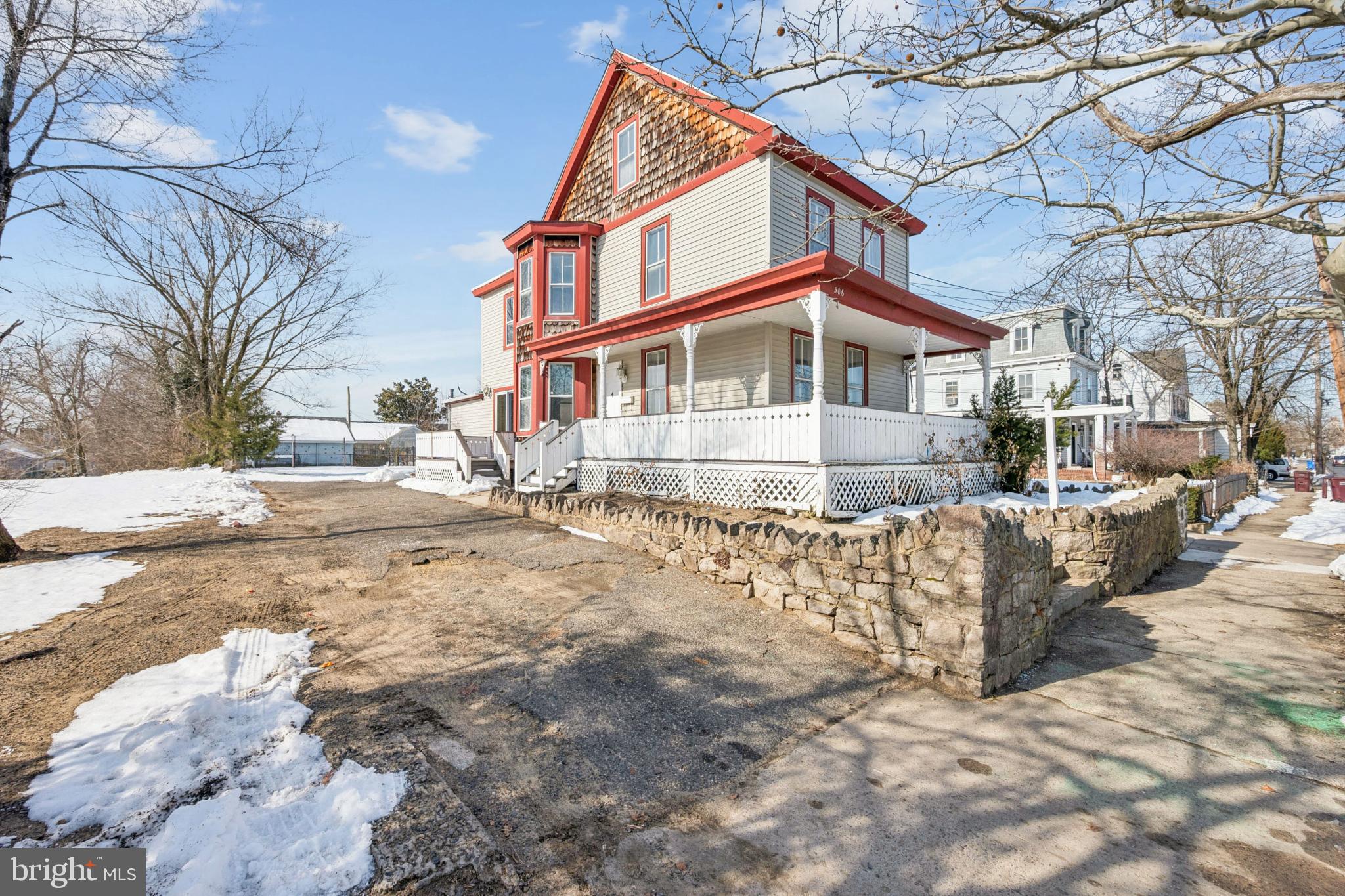 a front view of a house with a yard covered with snow