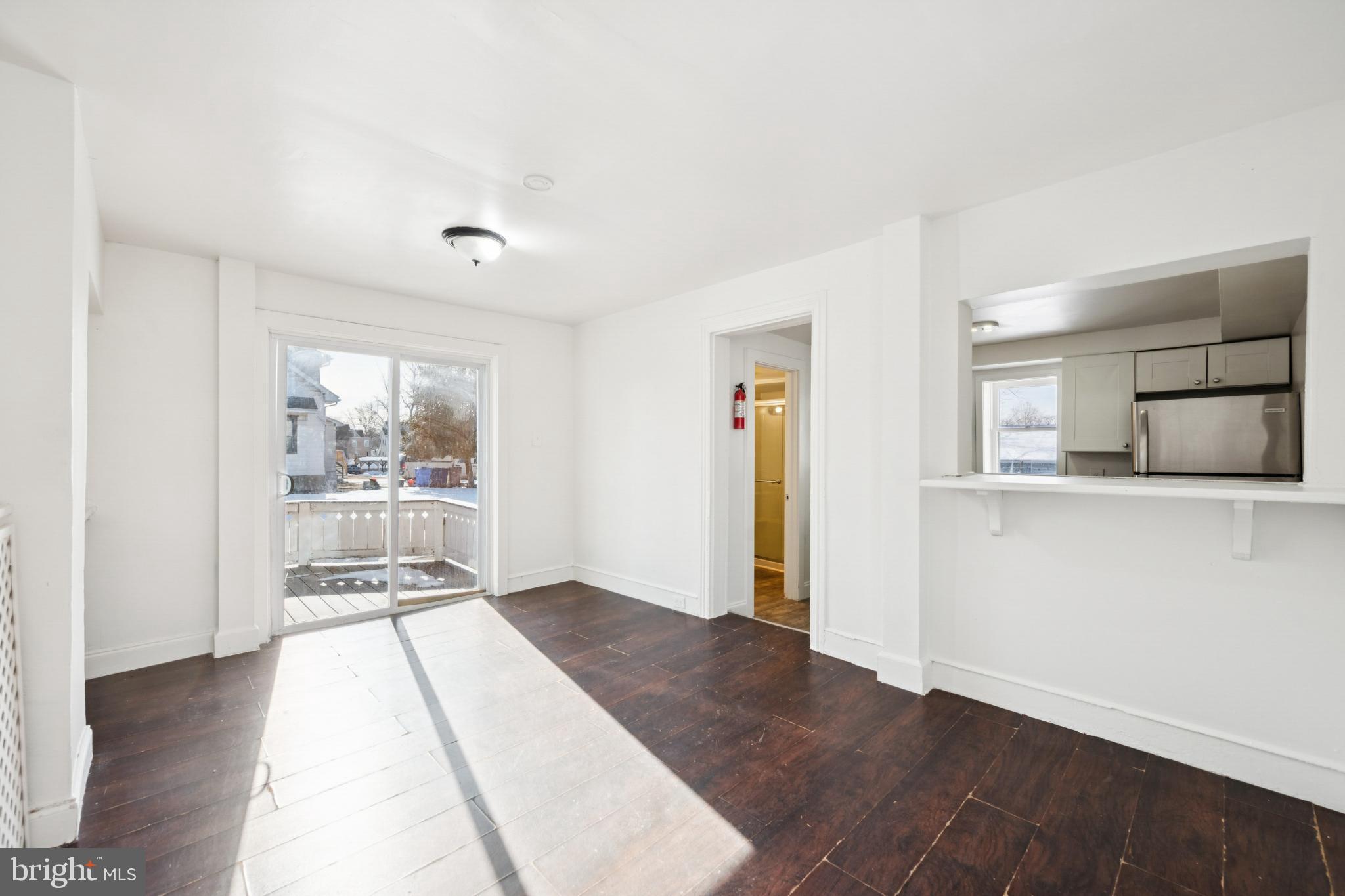 506 Bridgeboro Street Riverside, NJ 08075 - Photo 11 of 26 an empty room with wooden floor and windows