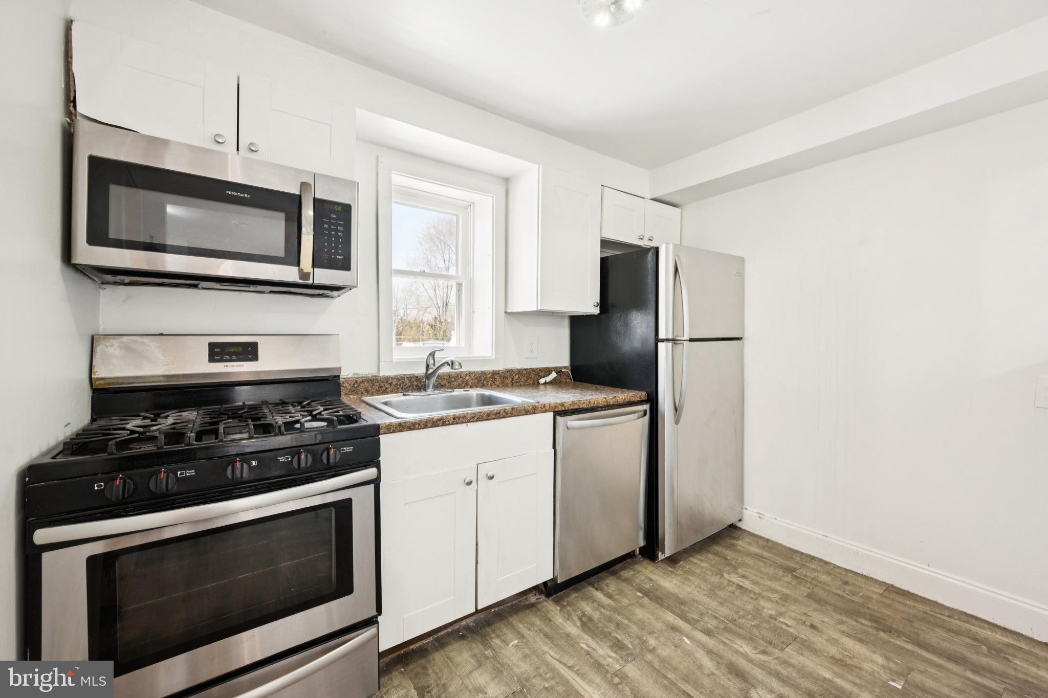 506 Bridgeboro Street Riverside, NJ 08075 - Photo 12 of 26 a kitchen with stainless steel appliances a stove a microwave a sink and cabinets