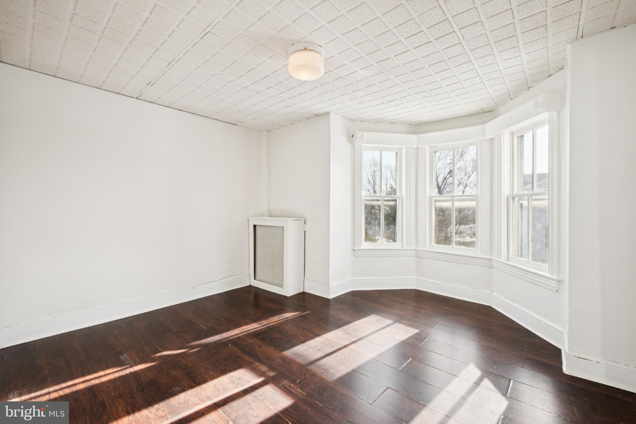 506 Bridgeboro Street Riverside, NJ 08075 - Photo 17 of 26 an empty room with wooden floor and windows