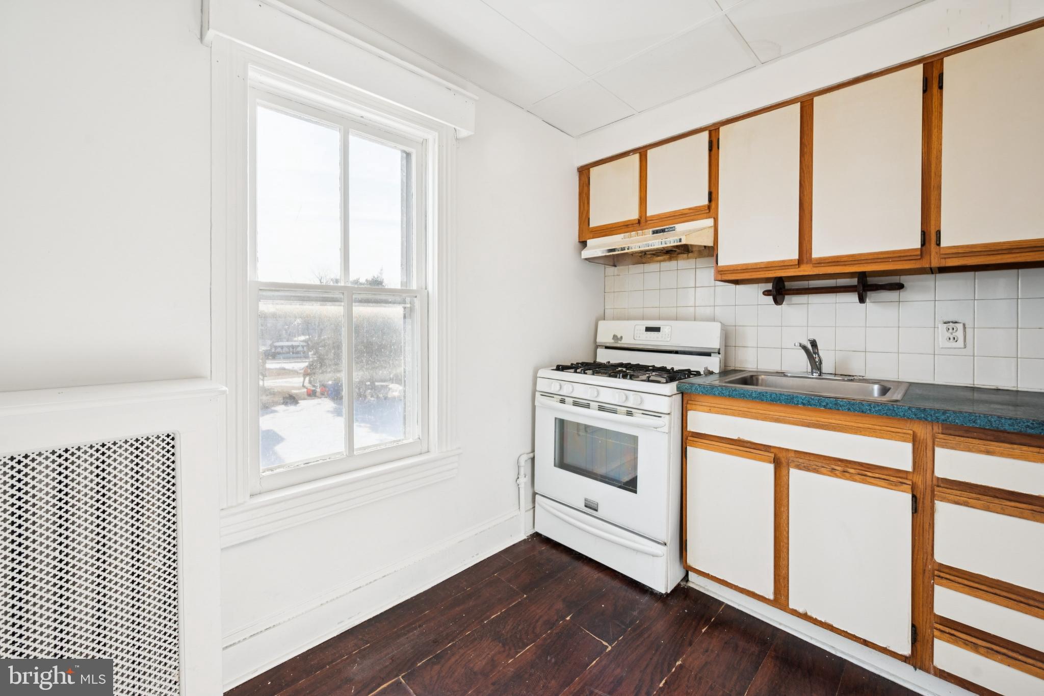 506 Bridgeboro Street Riverside, NJ 08075 - Photo 18 of 26 a kitchen with stainless steel appliances white cabinets and a window