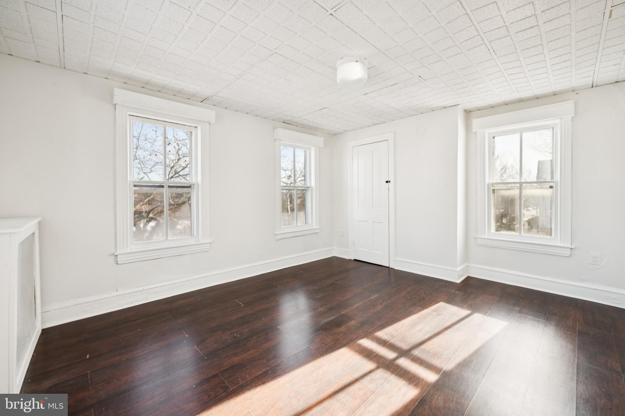 506 Bridgeboro Street Riverside, NJ 08075 - Photo 21 of 26 a view of an empty room with wooden floor and a window