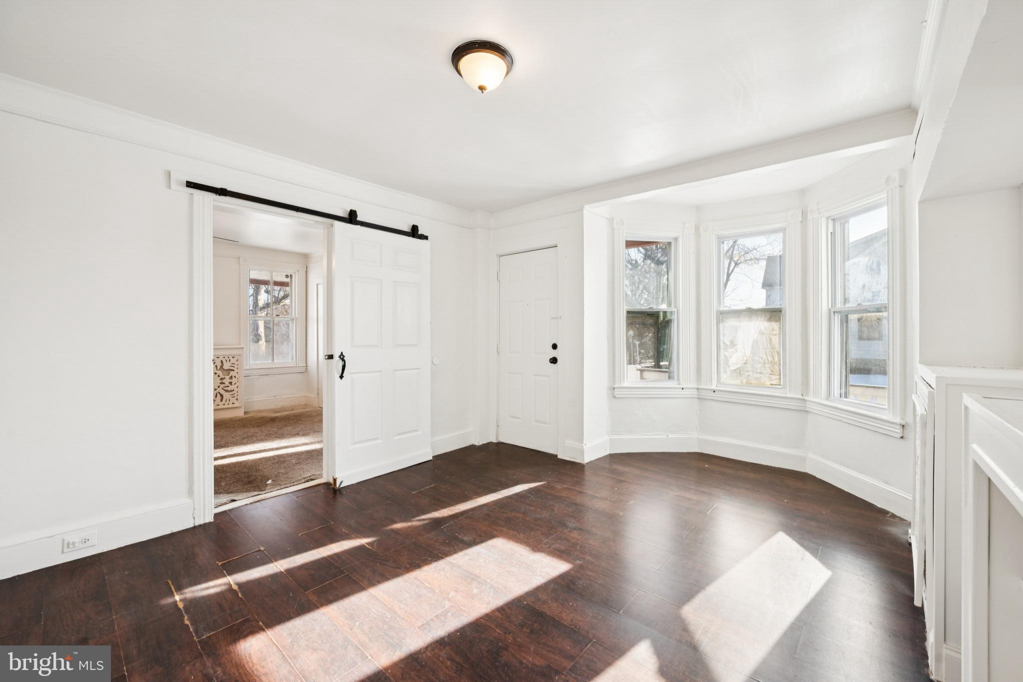 506 Bridgeboro Street Riverside, NJ 08075 - Photo 8 of 26 an empty room with wooden floor and windows