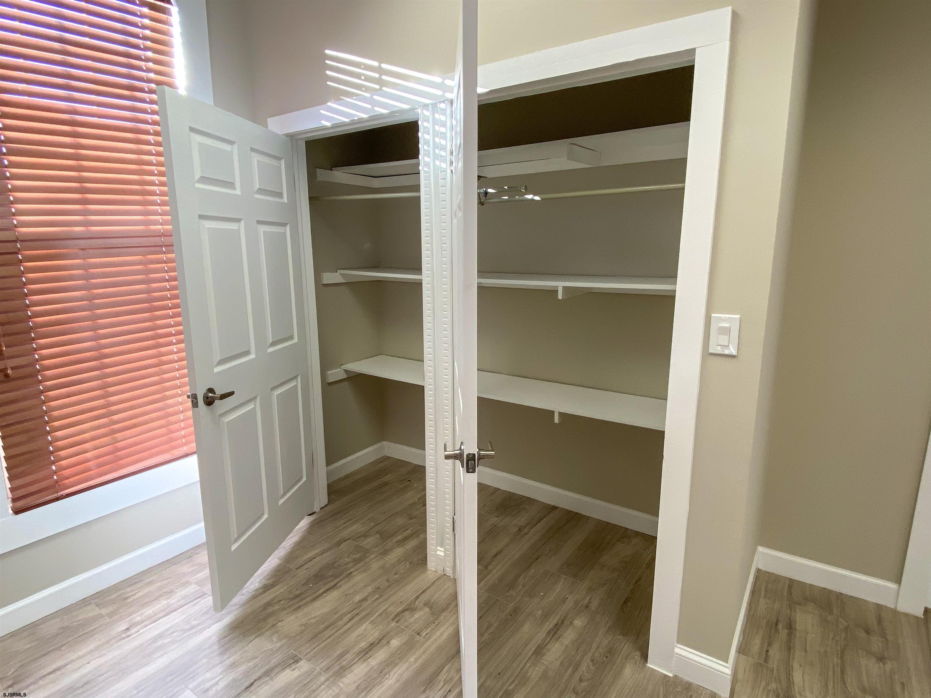6019 Main Street, Unit 2 Mays Landing, NJ 08330 - Photo 16 of 26 a view of walk in closet with empty racks