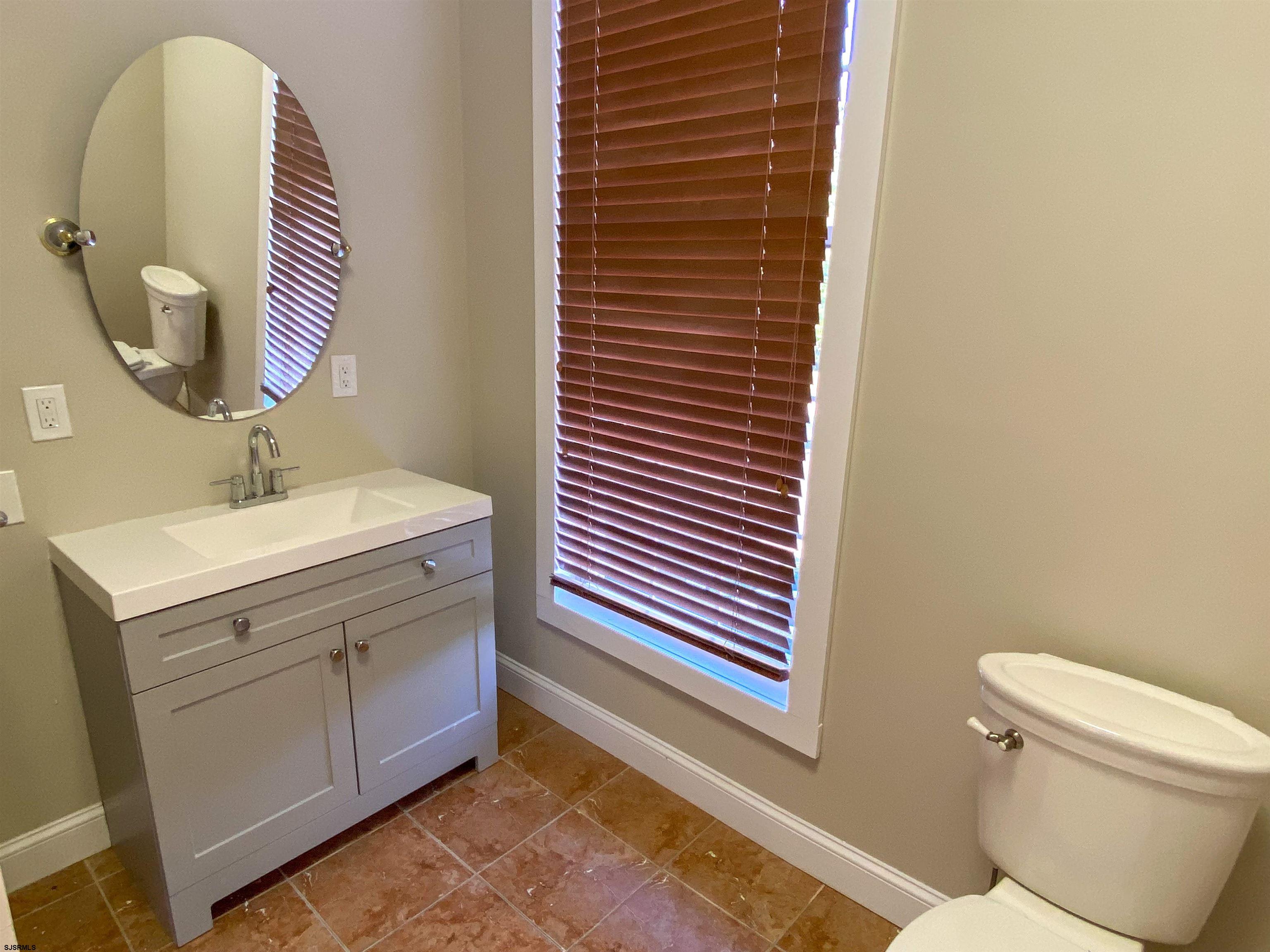 6019 Main Street, Unit 2 Mays Landing, NJ 08330 - Photo 22 of 26 a bathroom with a sink and a mirror
