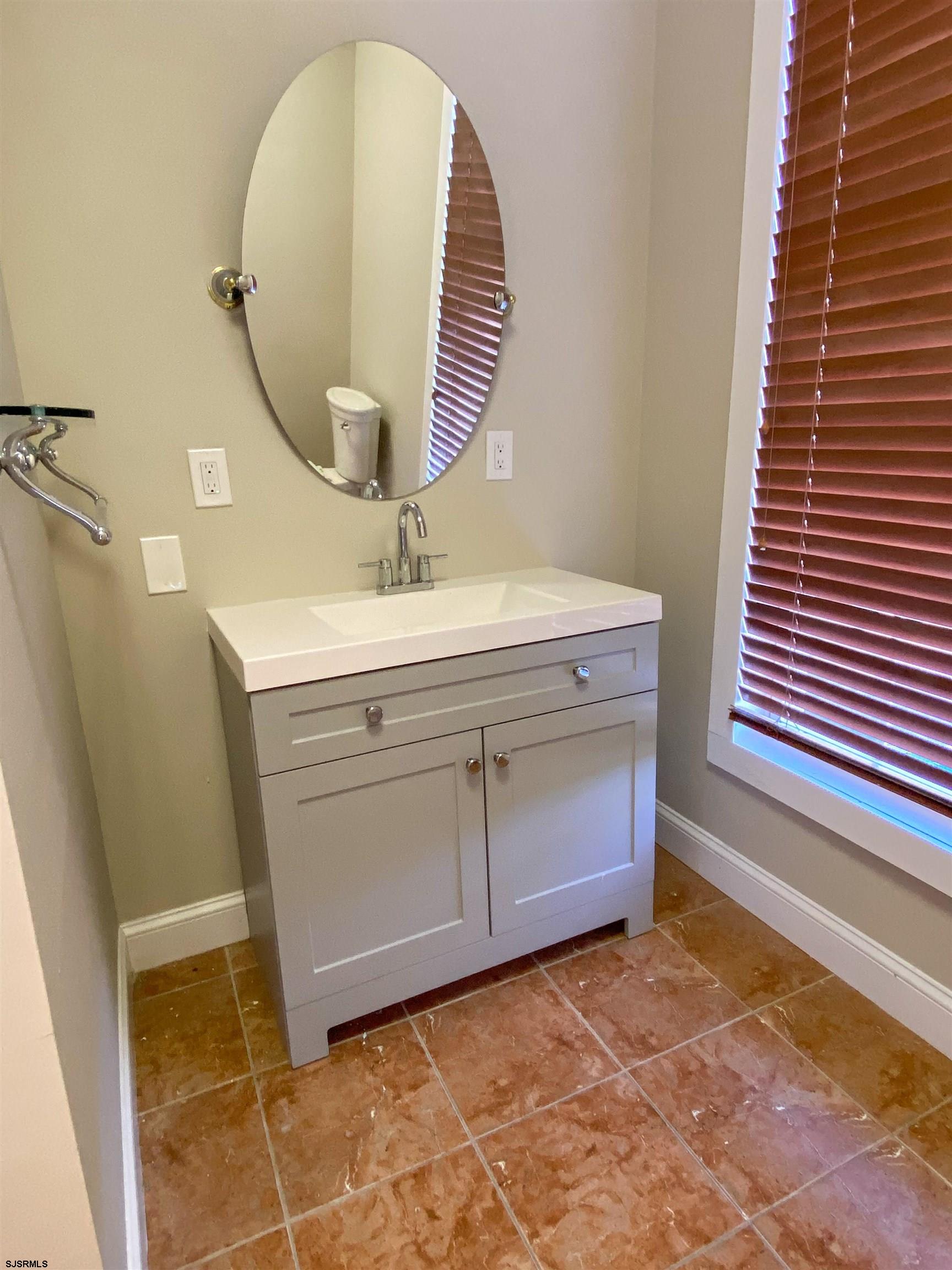 6019 Main Street, Unit 2 Mays Landing, NJ 08330 - Photo 23 of 26 a bathroom with a sink and a mirror