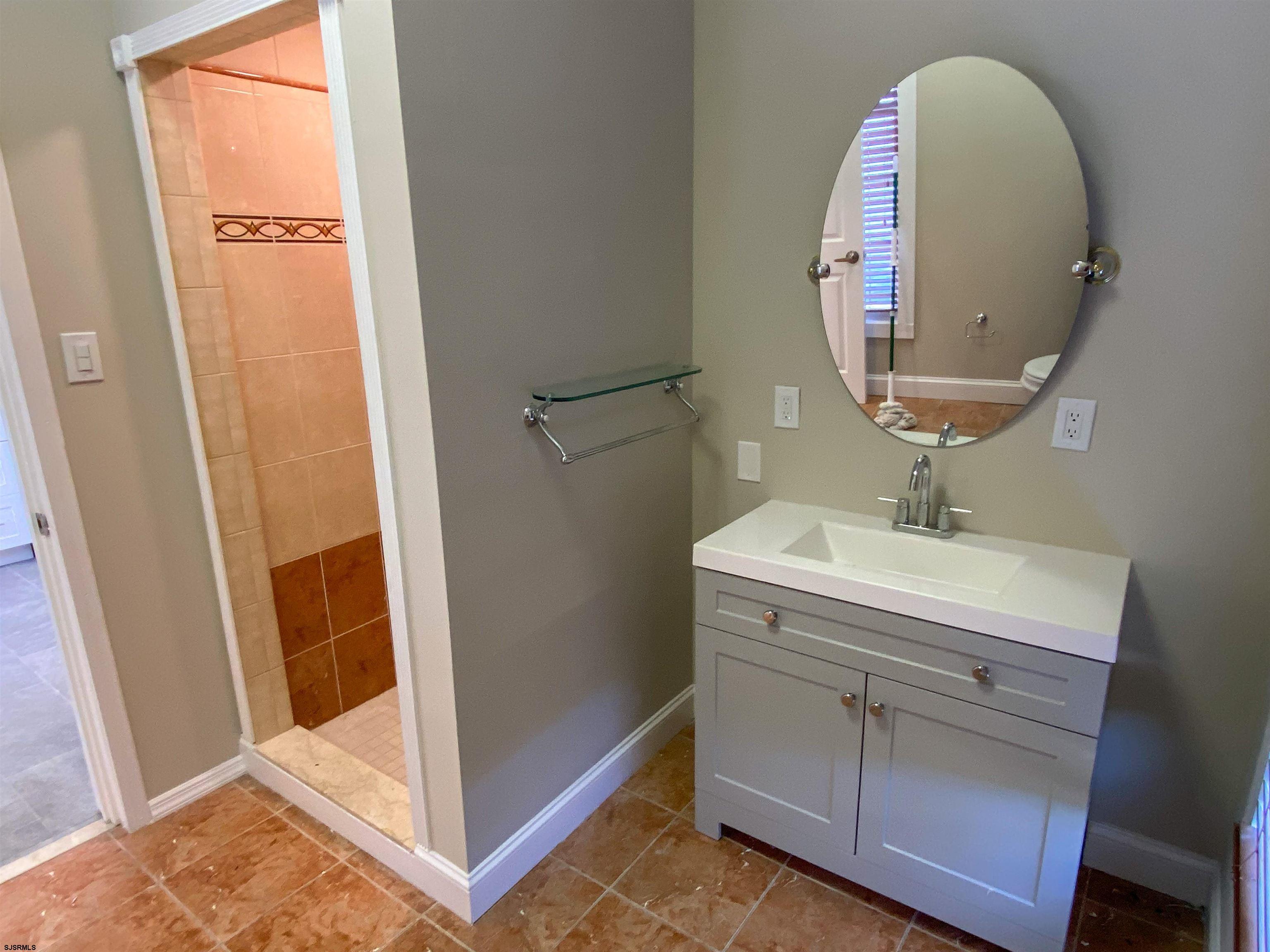 6019 Main Street, Unit 2 Mays Landing, NJ 08330 - Photo 24 of 26 a bathroom with a sink and a mirror