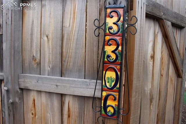 a backyard of a house with barbeque oven table and chairs