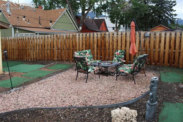 a view of a house with backyard and sitting area