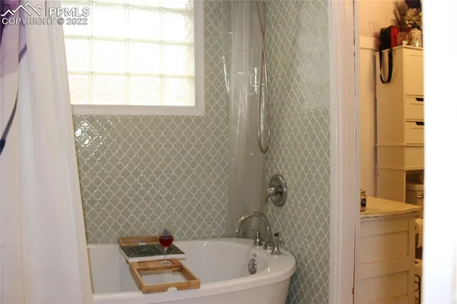 a bathroom with a bathtub and shower