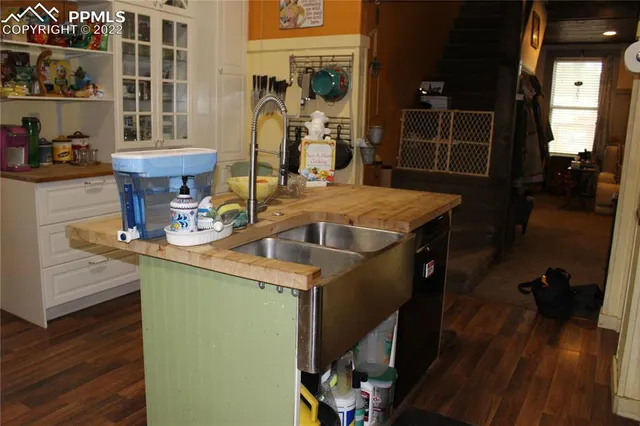 a room with wooden floor and furniture