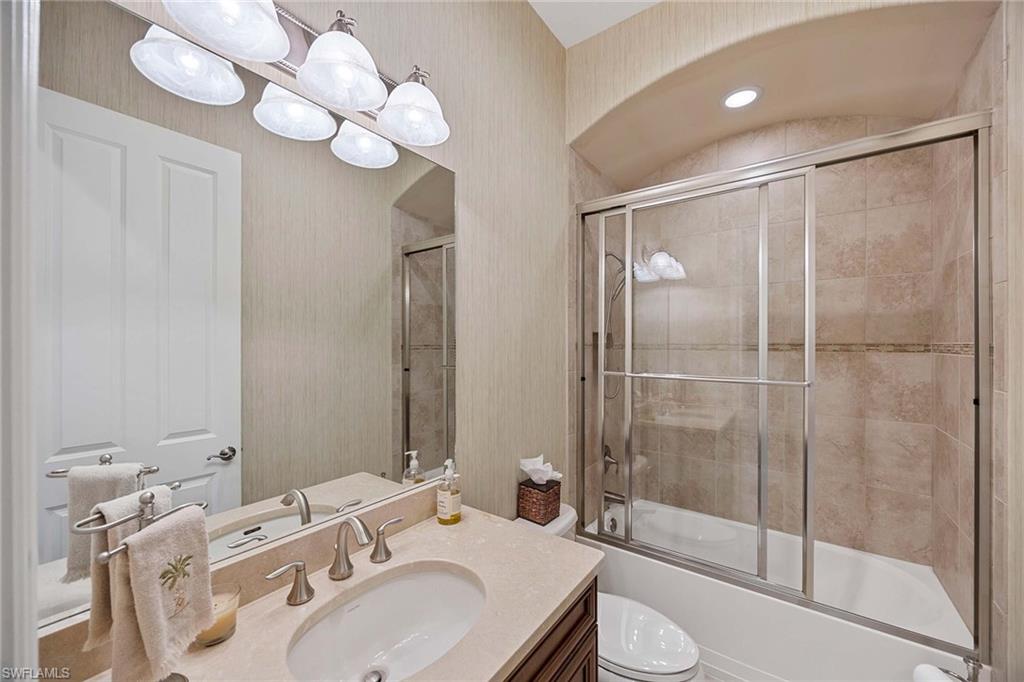 6255 Brunello Lane Naples, FL 34113 - Photo 21 of 37 a bathroom with a sink toilet and shower