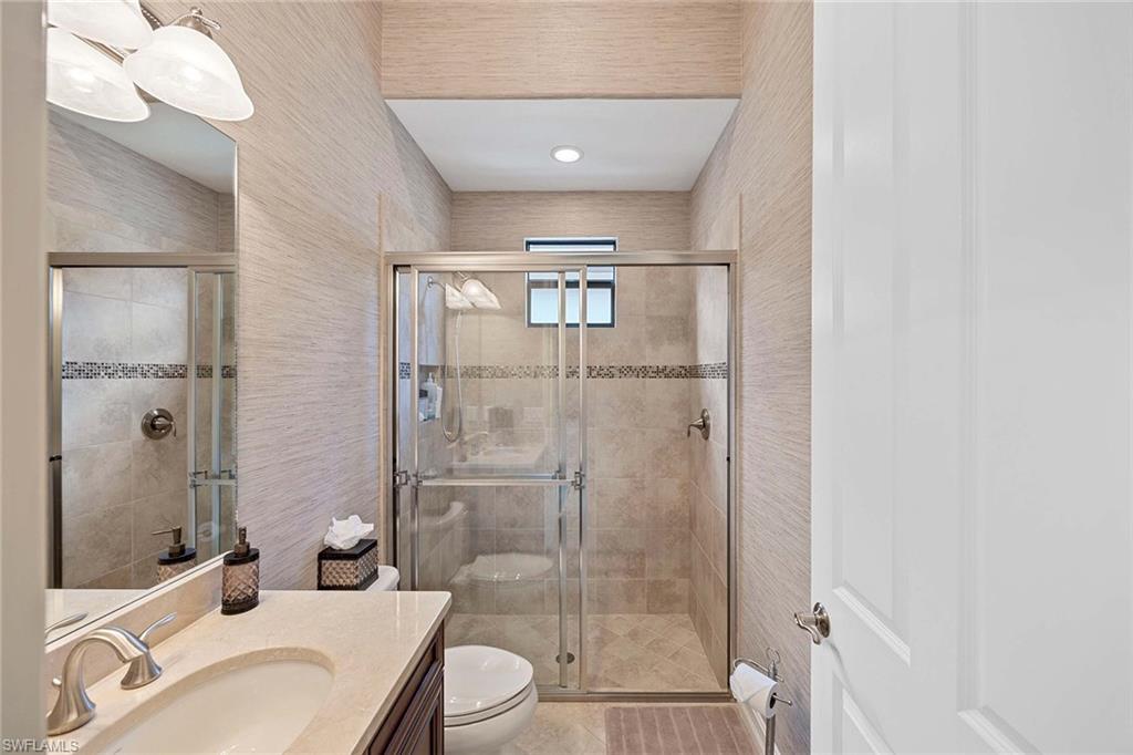 6255 Brunello Lane Naples, FL 34113 - Photo 23 of 37 a bathroom with a sink toilet and shower