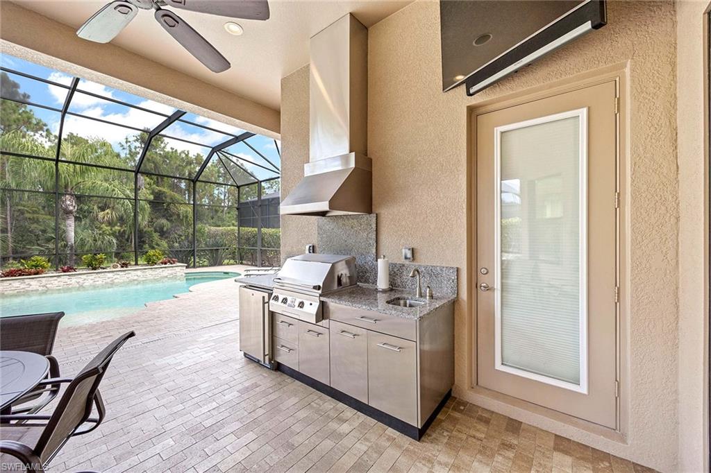 6255 Brunello Lane Naples, FL 34113 - Photo 25 of 37 a kitchen with a sink and a stove next to a window