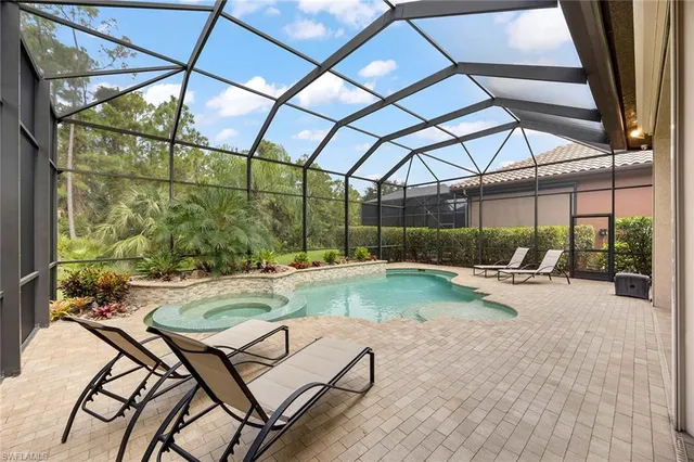 a view of swimming pool with outdoor seating and a yard